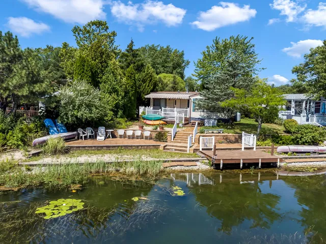 a view of a house with swimming pool and sitting area