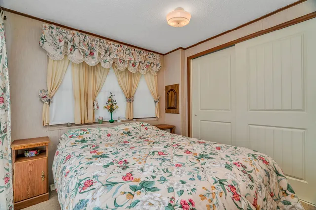 a bedroom with a bed and a window