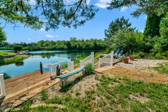 an outdoor sitting area with lake view