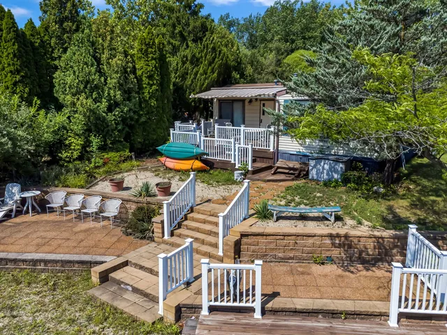 an aerial view of a house with swimming pool and patio