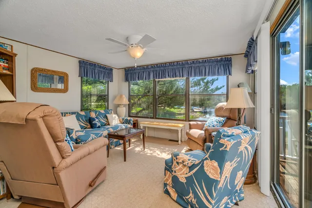 a living room with furniture and large windows
