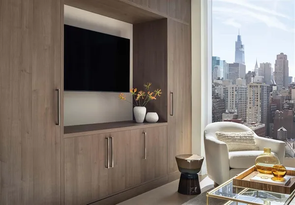 a bedroom with furniture and a large window