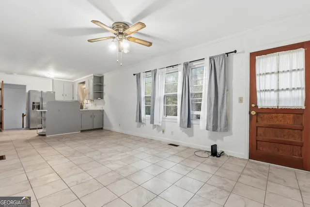 a view of a livingroom with furniture and natural light