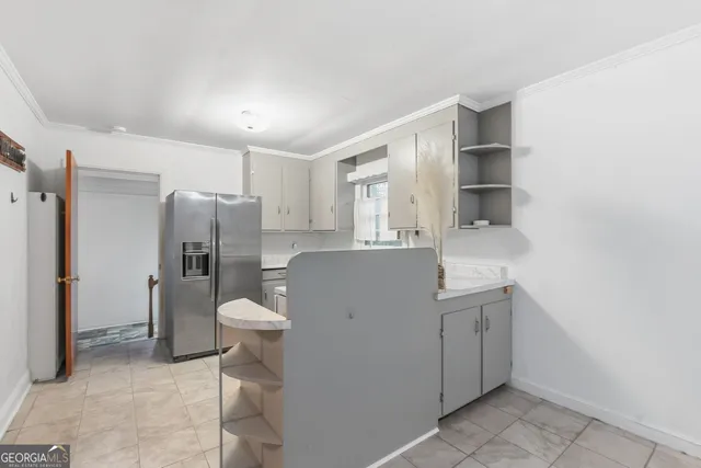 a kitchen with a sink cabinets and refrigerator