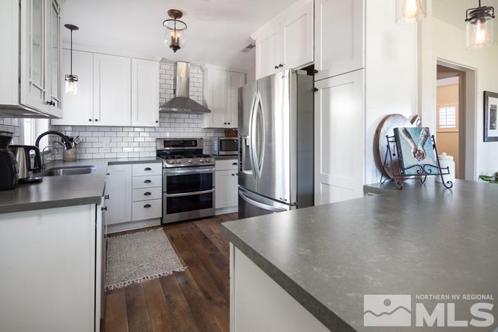 1345 Princess Avenue Reno, NV 89502 - Photo 14 of 23 a kitchen with stainless steel appliances granite countertop a stove a refrigerator and a view of living room