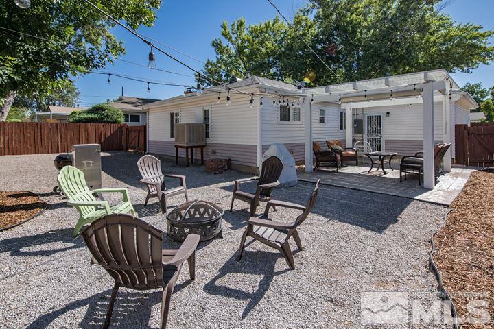 1345 Princess Avenue Reno, NV 89502 - Photo 20 of 23 a view of a patio with table and chairs with wooden floor and fence