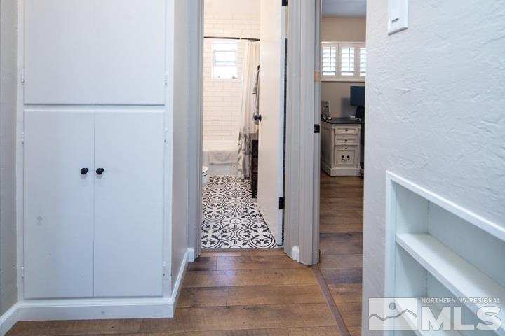 1345 Princess Avenue Reno, NV 89502 - Photo 7 of 23 a view of a hallway with wooden floor and staircase