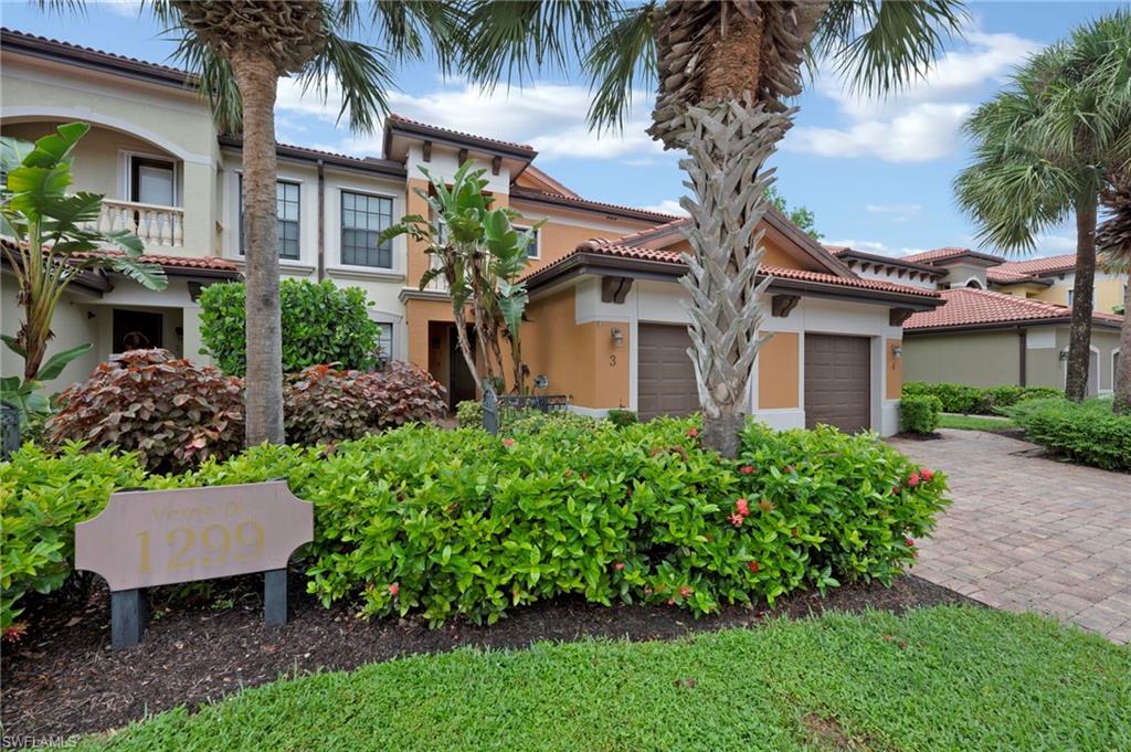 1299 Verde Drive, Unit 1503 Naples, FL 34105 - Photo 1 of 12 a front view of a house with a garden
