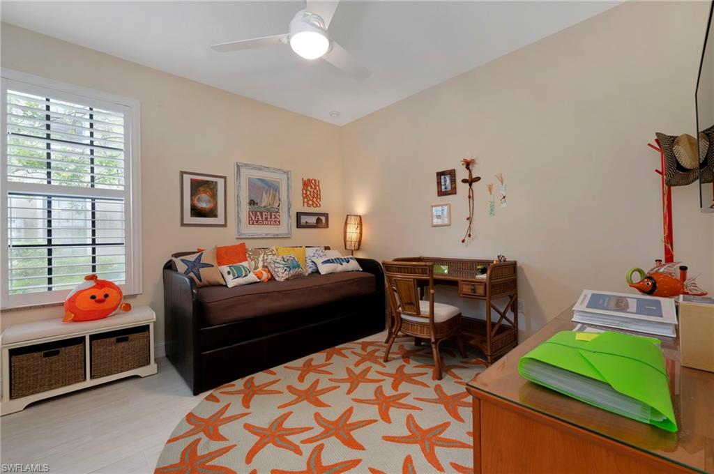 1299 Verde Drive, Unit 1503 Naples, FL 34105 - Photo 11 of 12 a bedroom with furniture and a chair