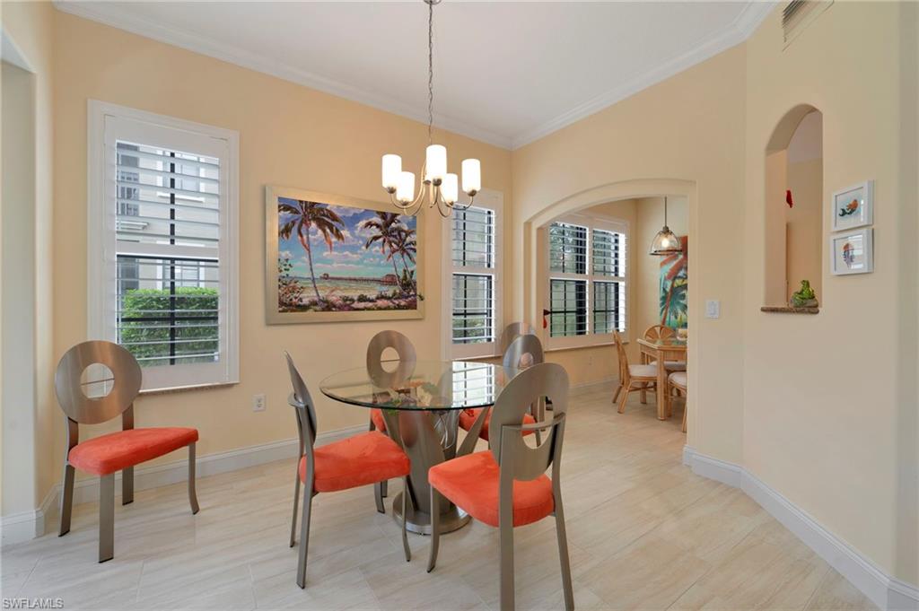 1299 Verde Drive, Unit 1503 Naples, FL 34105 - Photo 2 of 12 a view of a dining room with furniture and a chandelier