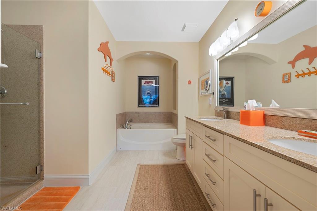 1299 Verde Drive, Unit 1503 Naples, FL 34105 - Photo 5 of 12 a spacious bathroom with a sink a mirror and a bathtub
