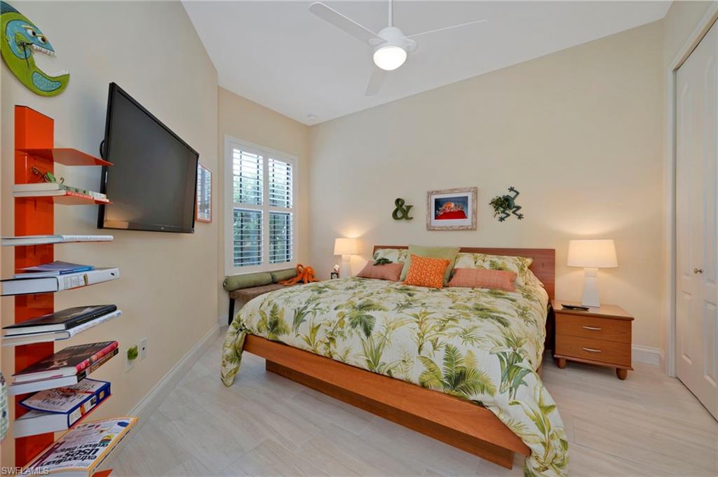 1299 Verde Drive, Unit 1503 Naples, FL 34105 - Photo 6 of 12 a bedroom with a bed and a flat screen tv