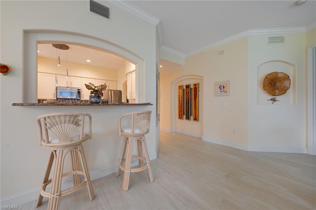 1299 Verde Drive, Unit 1503 Naples, FL 34105 - Photo 10 of 12 a dining room with furniture and window