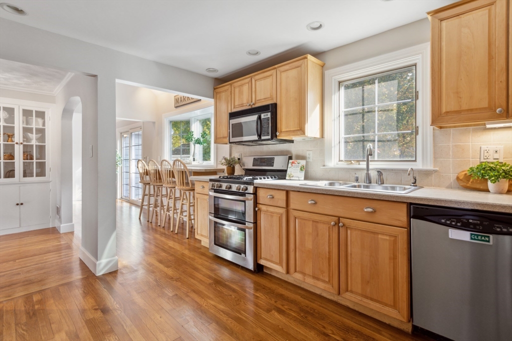 16 Meriam Street Wakefield, MA 01880 - Photo 12 of 42 a kitchen with stainless steel appliances granite countertop a stove top oven a sink dishwasher a refrigerator and cabinets with wooden floor