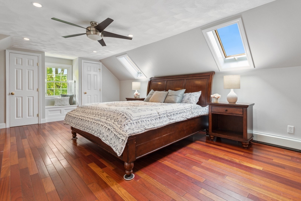 16 Meriam Street Wakefield, MA 01880 - Photo 26 of 42 a bedroom with a bed and a chandelier