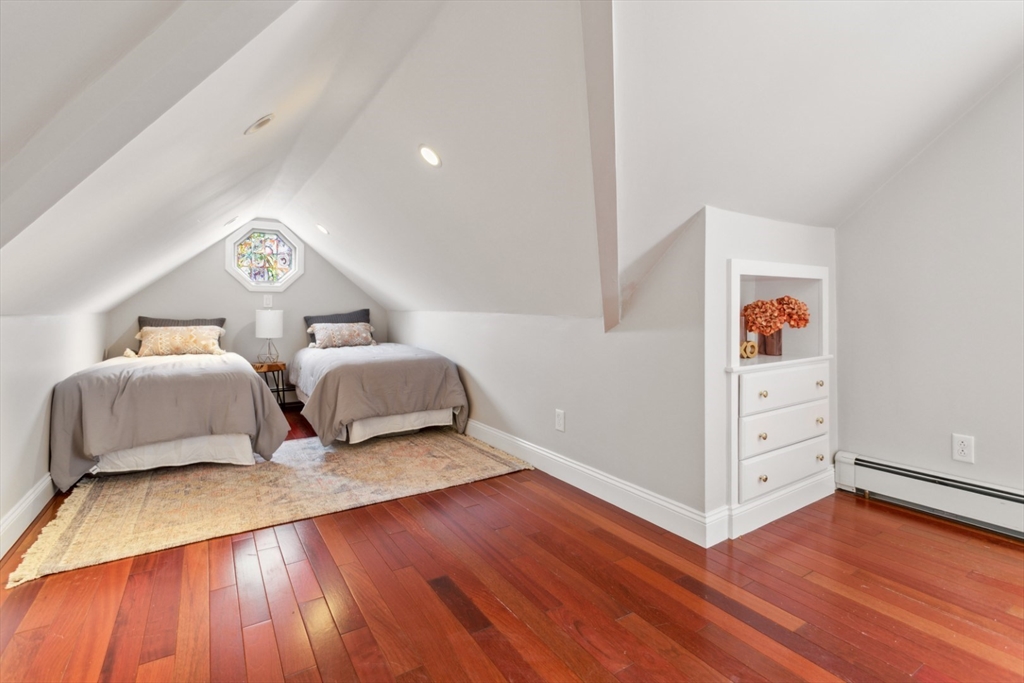 16 Meriam Street Wakefield, MA 01880 - Photo 30 of 42 a spacious bedroom with a bed and wooden floor