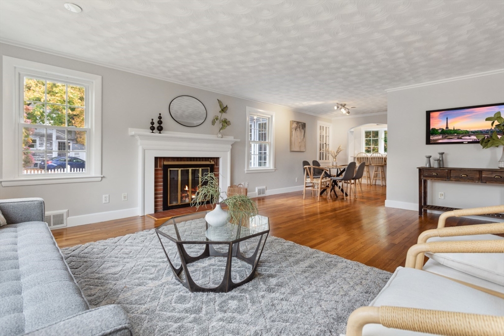 16 Meriam Street Wakefield, MA 01880 - Photo 6 of 42 a living room with furniture a fireplace a rug and a large window