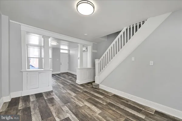 a view of entryway and hall with wooden floor