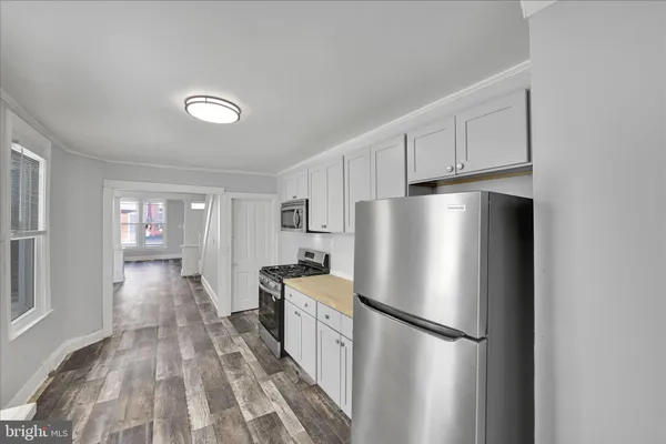 a white refrigerator freezer sitting inside of a kitchen
