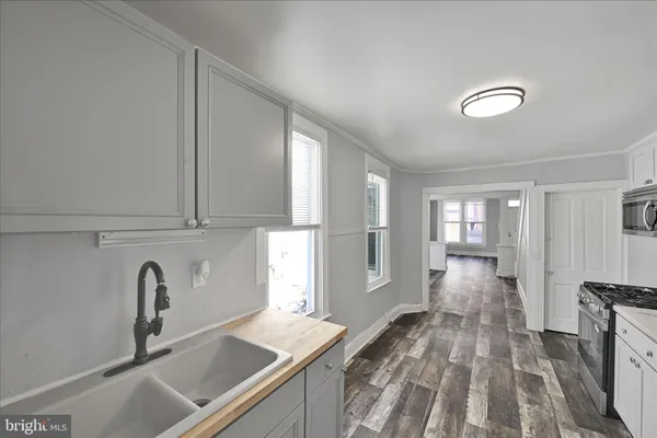 a view of a kitchen with a sink dishwasher refrigerator stove and cabinets