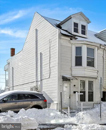 a front view of a house with parking space