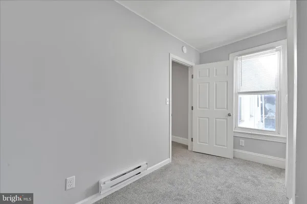 an empty room with windows and closet