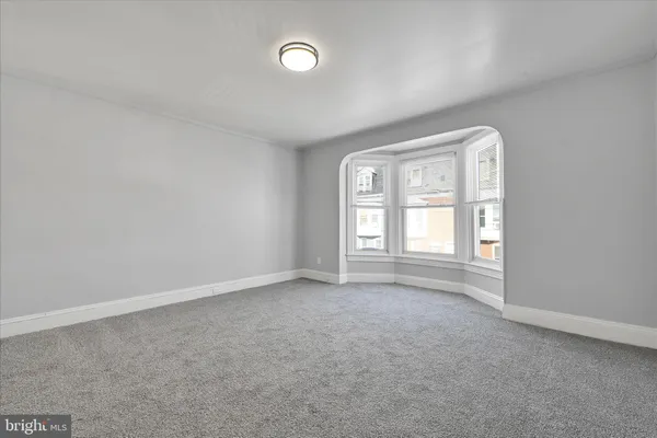 an empty room with windows and closet