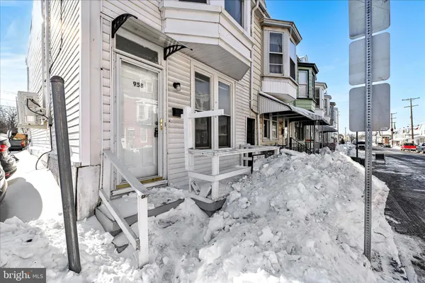 a row of palm trees in front of a building