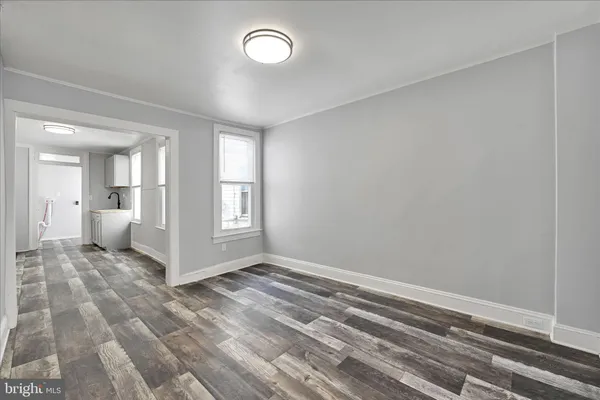 a view of a room with a stylish room and wooden floor