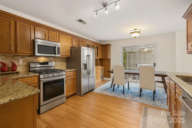 a bathroom with a granite countertop sink and a mirror with bathtub
