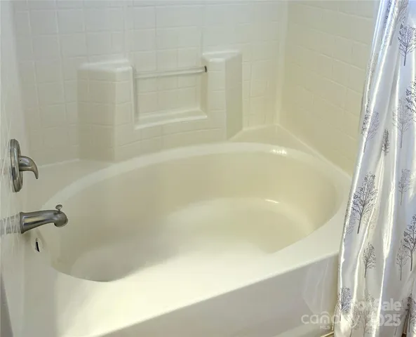 an aerial view of residential house with outdoor space and trees all around