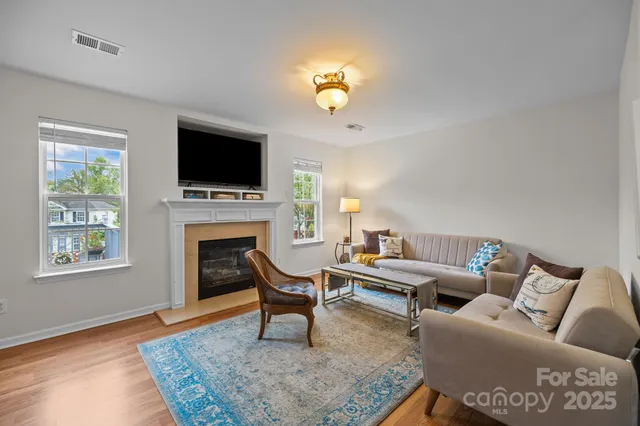 a living room with furniture and painting on the wall