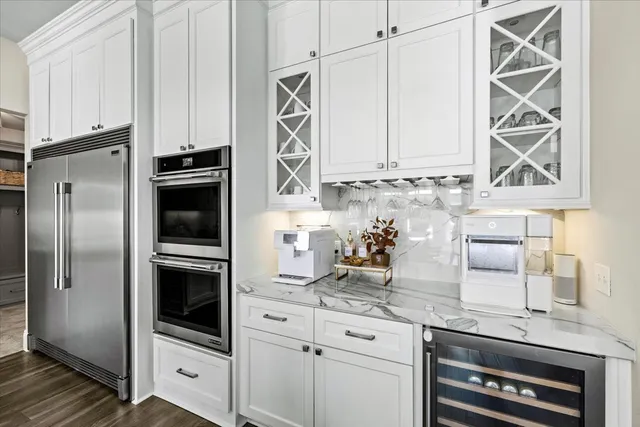 a kitchen with appliances a sink and cabinets