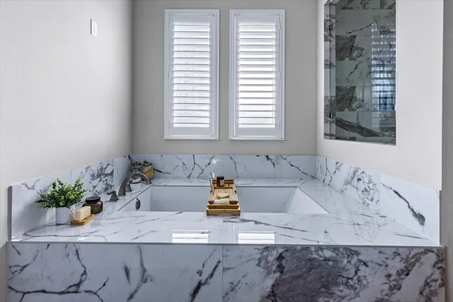 a bathroom with a bathtub and a sink