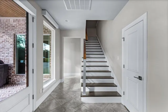 a kitchen with a granite countertop sink a mirror and a plant