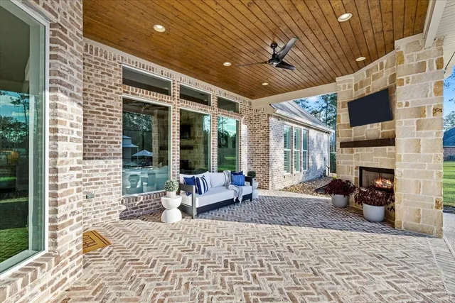 a living room with furniture a flat screen tv and a fireplace