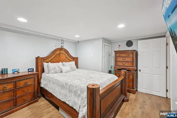 a bedroom with a bed and a dresser in it