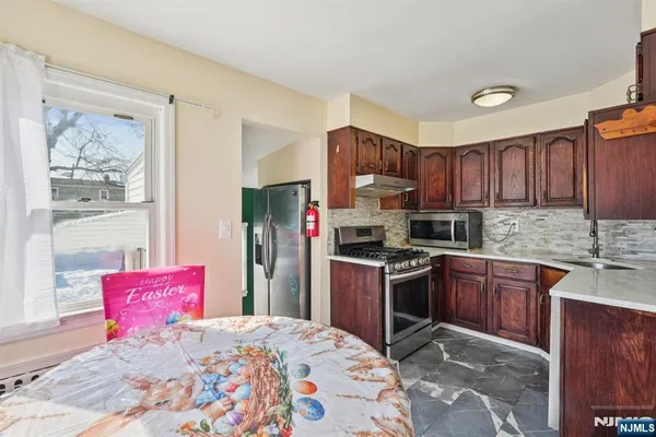 a kitchen with stainless steel appliances granite countertop a refrigerator stove top oven a sink and dishwasher