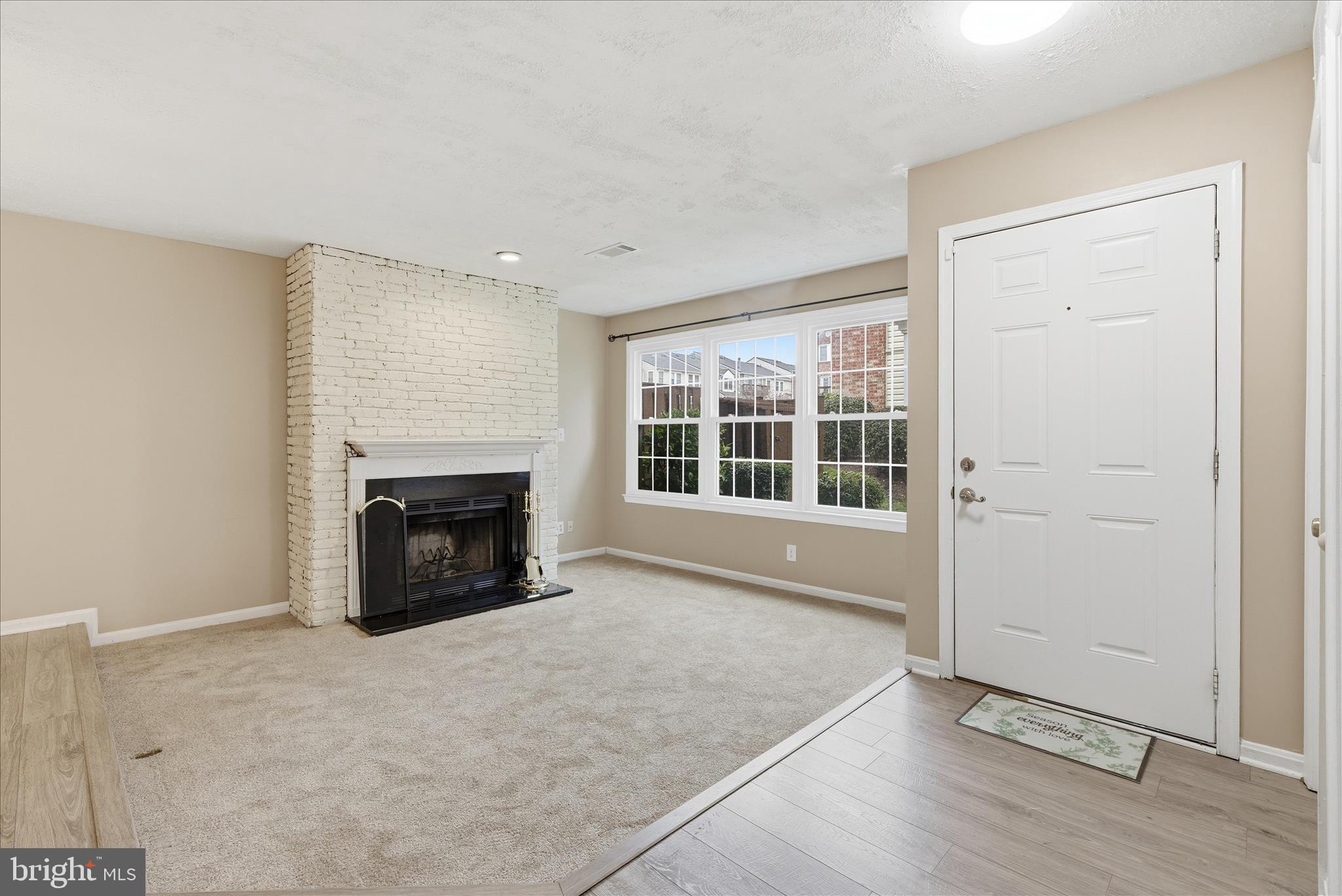 4167 Churchman Way Woodbridge, VA 22192 - Photo 11 of 36 an empty room with fireplace and windows