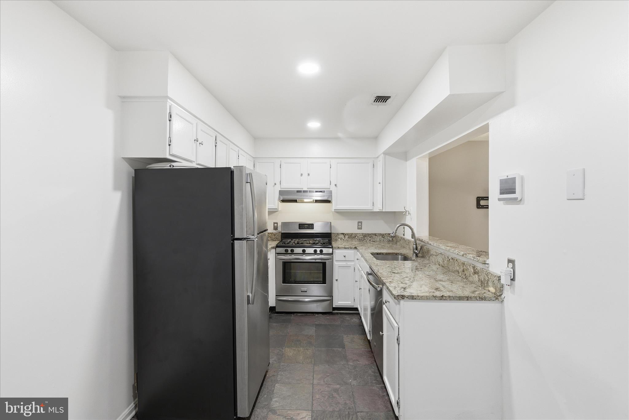 4167 Churchman Way Woodbridge, VA 22192 - Photo 15 of 36 a kitchen with a refrigerator stove and sink