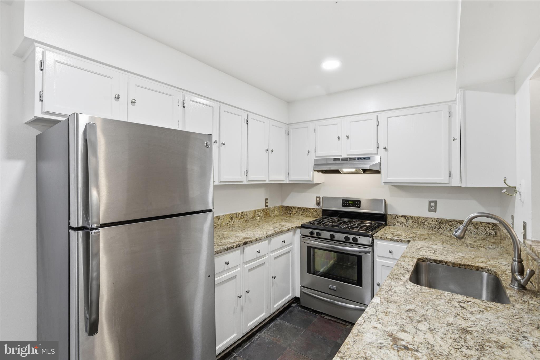 4167 Churchman Way Woodbridge, VA 22192 - Photo 17 of 36 a kitchen with refrigerator a stove a sink and cabinets