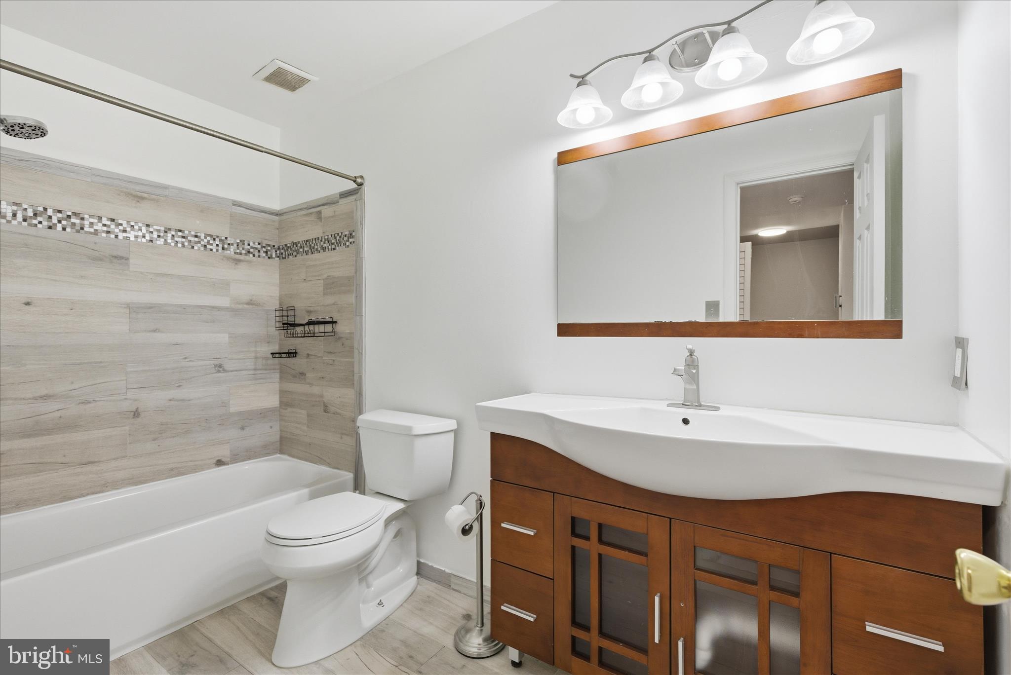 4167 Churchman Way Woodbridge, VA 22192 - Photo 25 of 36 a bathroom with a sink a toilet and shower