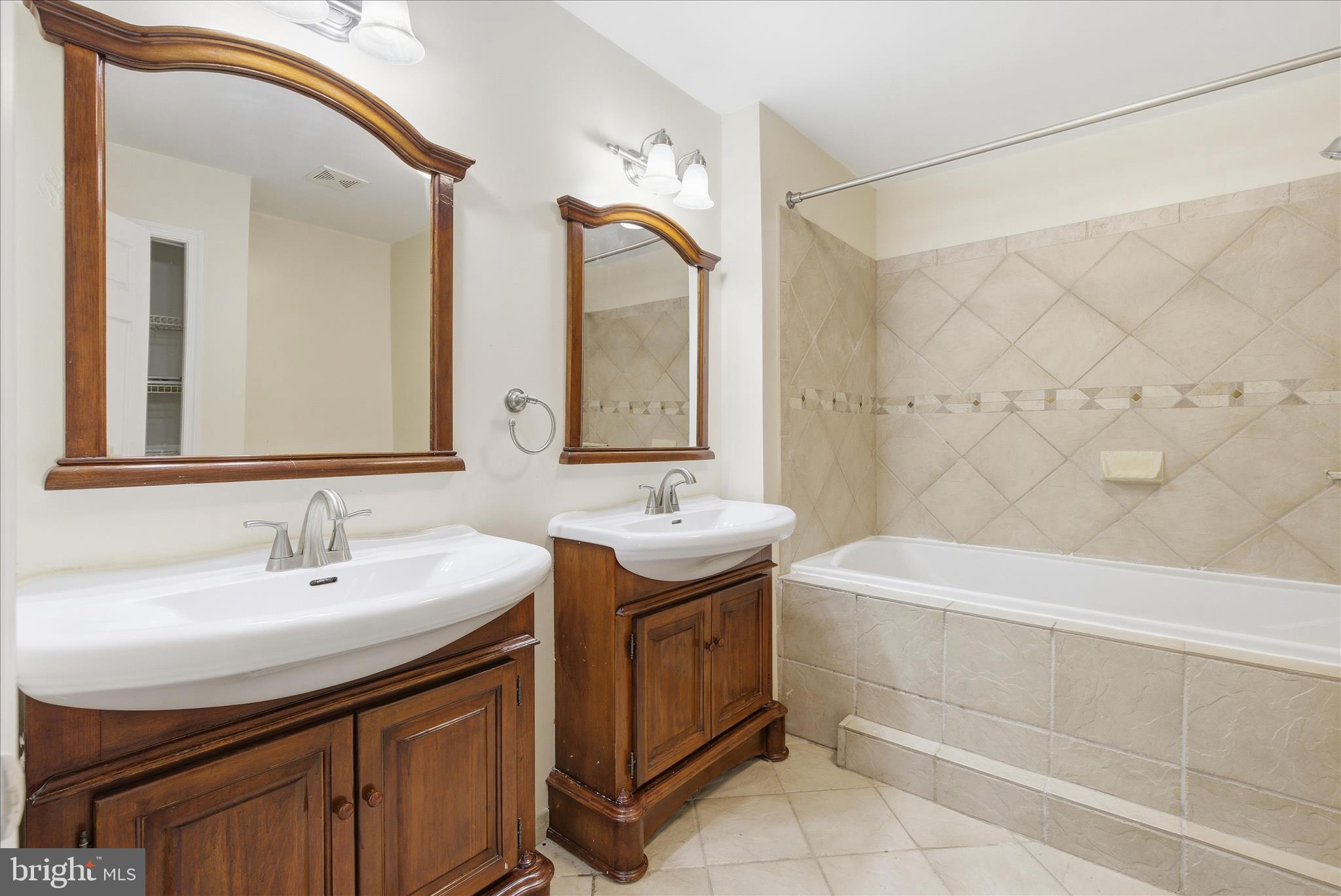4167 Churchman Way Woodbridge, VA 22192 - Photo 31 of 36 a bathroom with a double vanity sink mirror and bathtub