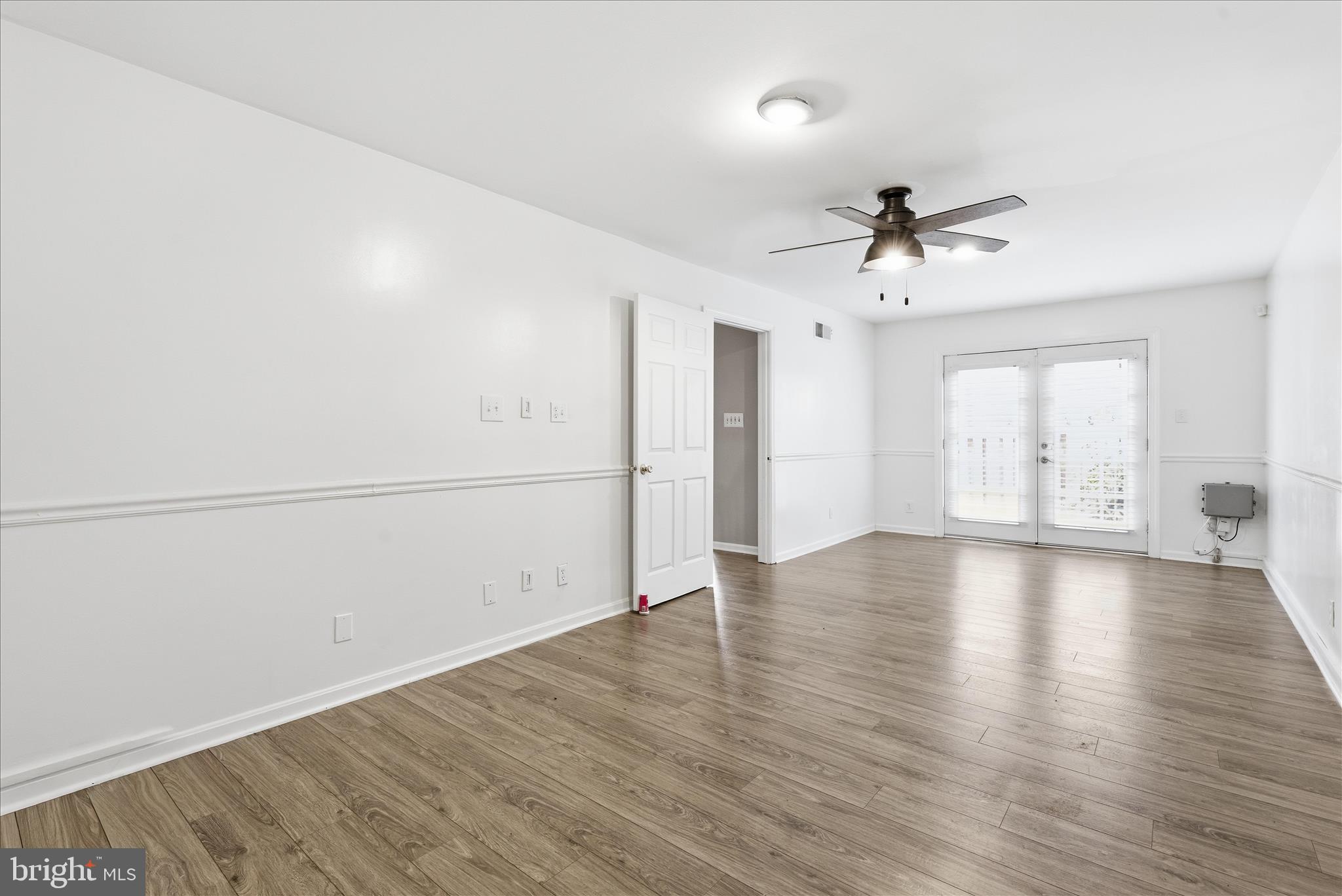 4167 Churchman Way Woodbridge, VA 22192 - Photo 35 of 36 an empty room with wooden floor and ceiling fan