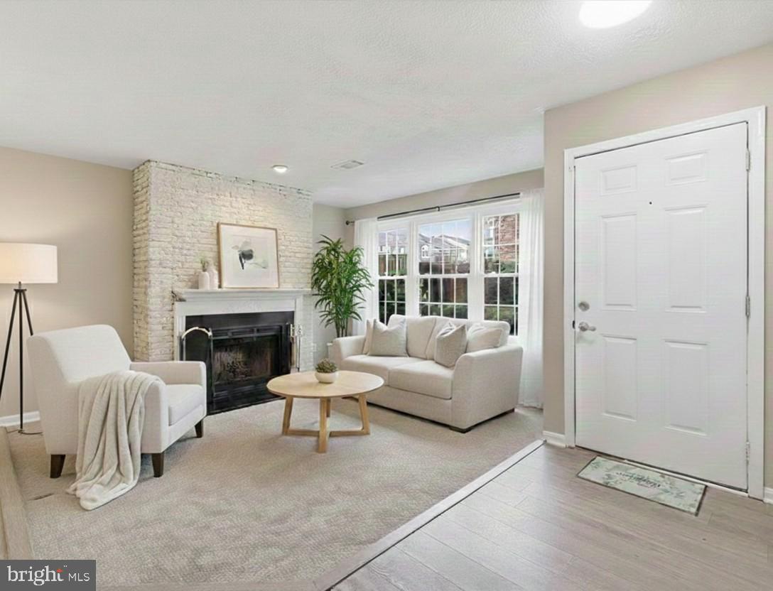 4167 Churchman Way Woodbridge, VA 22192 - Photo 10 of 36 a living room with furniture and a fireplace
