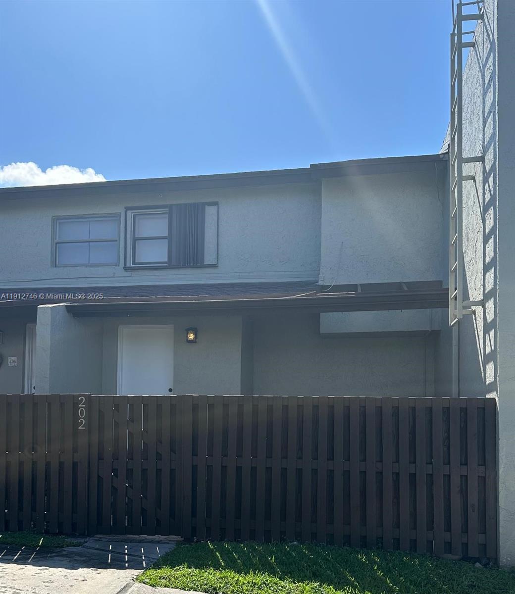 10040 Northwest 9th St Circle, Unit 202 Miami, FL 33172 - Photo 14 of 17 a kitchen with a cabinets and wooden floor