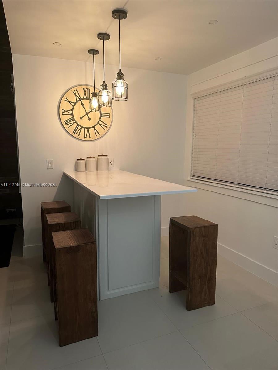 10040 Northwest 9th St Circle, Unit 202 Miami, FL 33172 - Photo 2 of 17 a kitchen with a refrigerator and cabinets