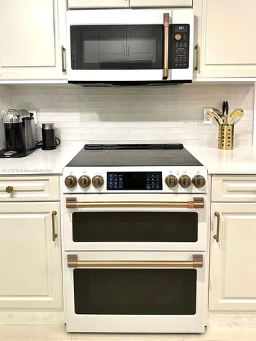 a stove top oven sitting inside of a kitchen
