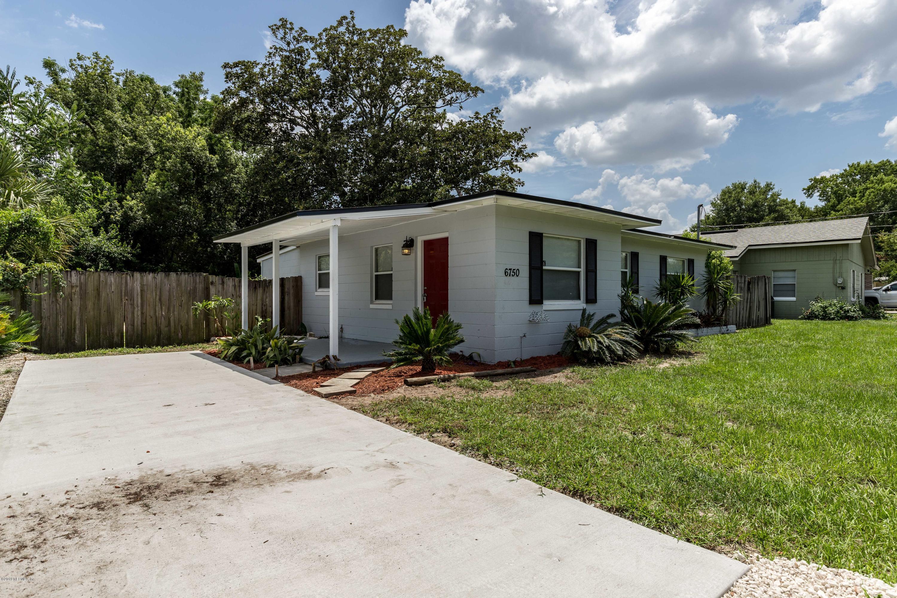 6750 Banbury Road Jacksonville, FL 32211 - Photo 2 of 45 a front view of house with yard and trees around