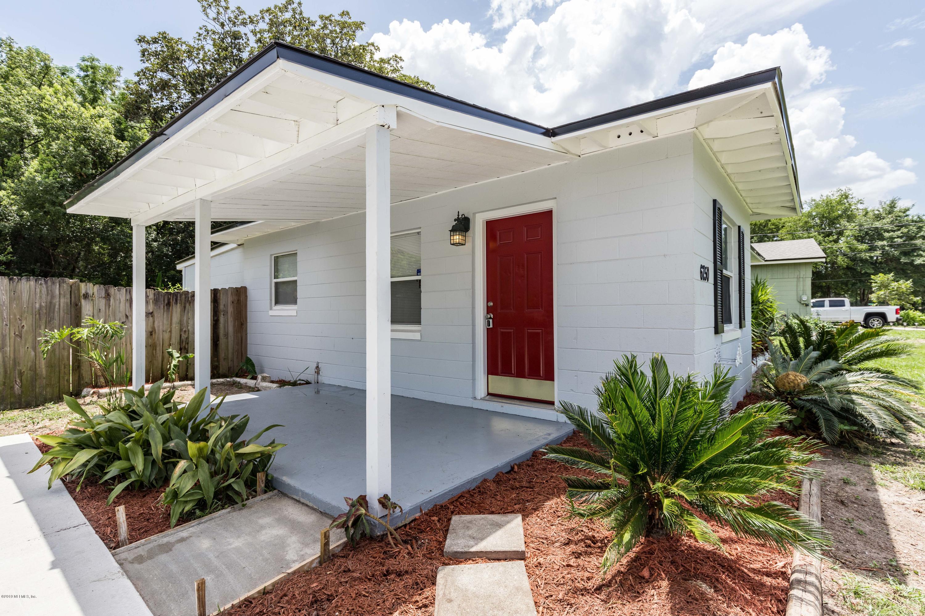 6750 Banbury Road Jacksonville, FL 32211 - Photo 3 of 45 a front view of a house with a yard